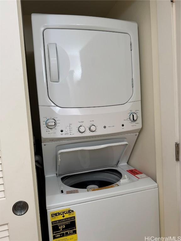 clothes washing area featuring stacked washer and dryer