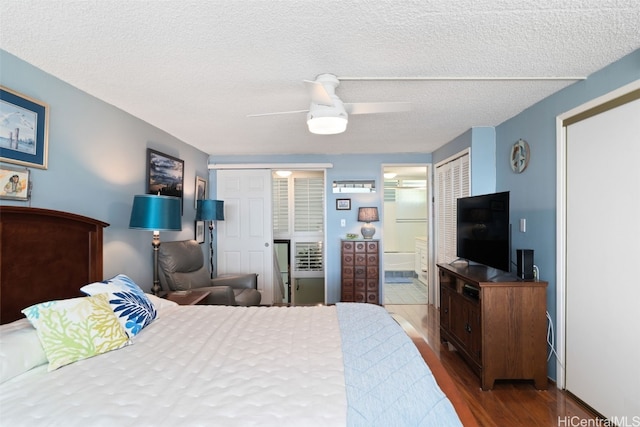 bedroom with hardwood / wood-style flooring, ceiling fan, connected bathroom, and a textured ceiling