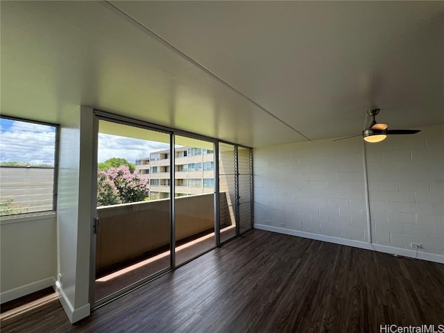 unfurnished sunroom featuring ceiling fan