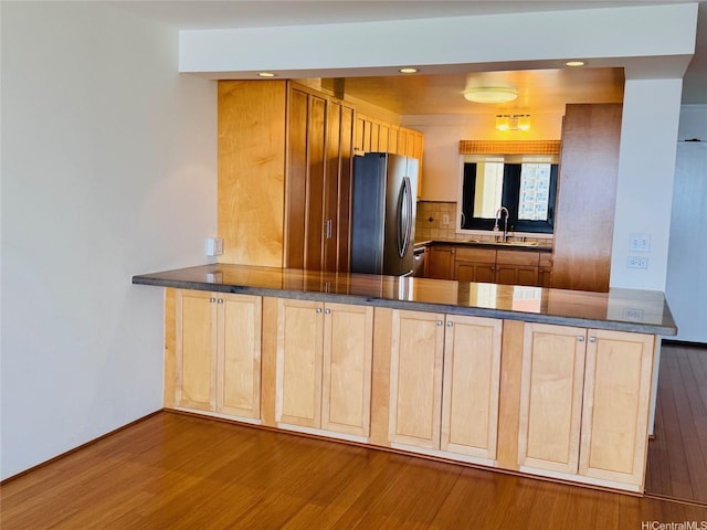 1600 Ala Moana Blvd Unit 3202, Honolulu, HI 96814 - kitchen with a sink, light brown cabinets, freestanding refrigerator, wood finished floors, and tasteful backsplash