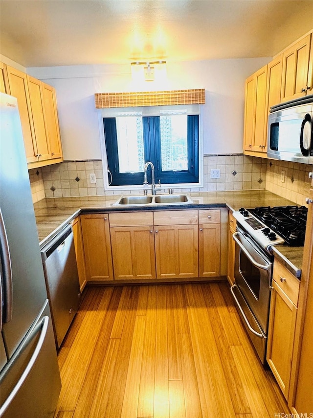 1600 Ala Moana Blvd Unit 3202, Honolulu, HI 96814 - kitchen with light wood-style floors, a sink, decorative backsplash, and appliances with stainless steel finishes