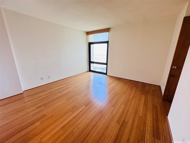 1600 Ala Moana Blvd Unit 3202, Honolulu, HI 96814 - empty room with light wood-type flooring and floor to ceiling windows