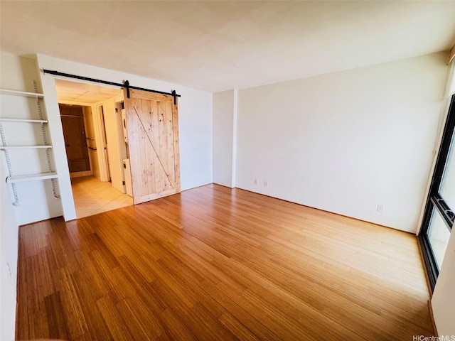 1600 Ala Moana Blvd Unit 3202, Honolulu, HI 96814 - spare room with a barn door and wood finished floors