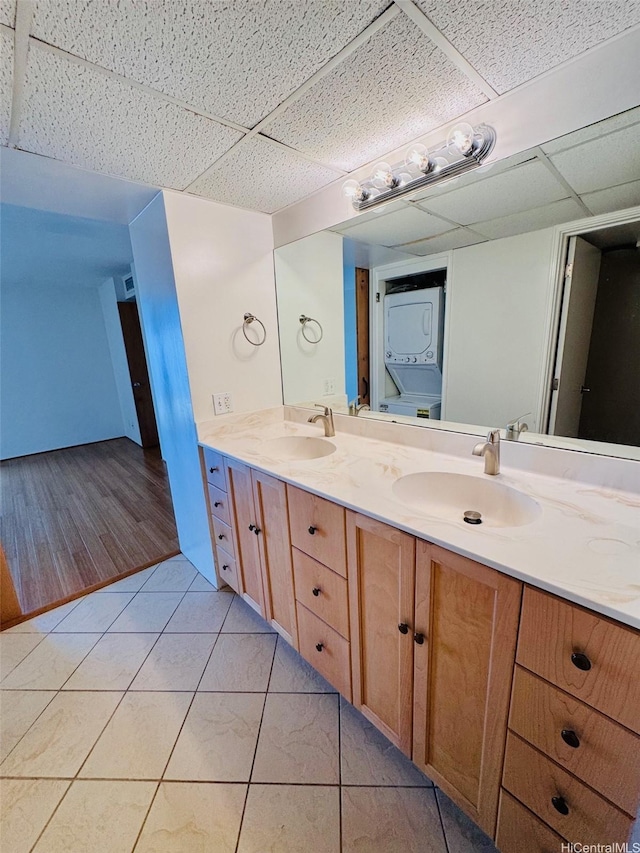1600 Ala Moana Blvd Unit 3202, Honolulu, HI 96814 - bathroom featuring a sink, stacked washer / drying machine, a drop ceiling, and double vanity