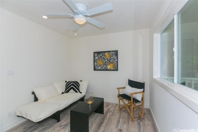 living room featuring hardwood / wood-style flooring and ceiling fan