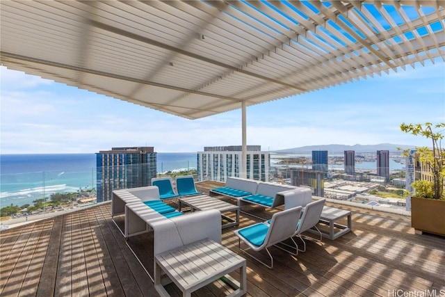 deck with a city view, a water view, and an outdoor living space