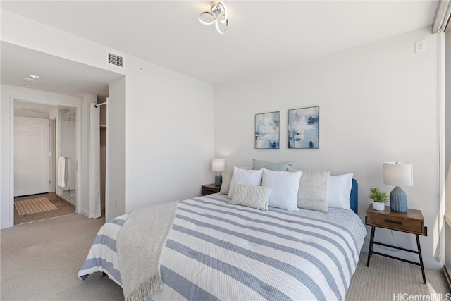 bedroom featuring visible vents and light colored carpet