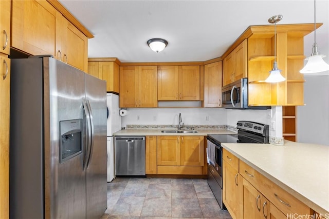 kitchen with hanging light fixtures, stainless steel appliances, light countertops, open shelves, and a sink