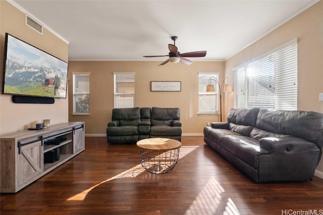 living area featuring ornamental molding, dark wood-type flooring, and baseboards