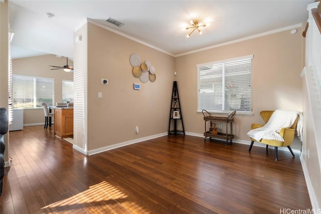 living area featuring dark wood-style floors, visible vents, ornamental molding, ceiling fan, and baseboards