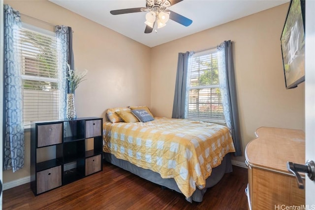 bedroom featuring ceiling fan, baseboards, and wood finished floors