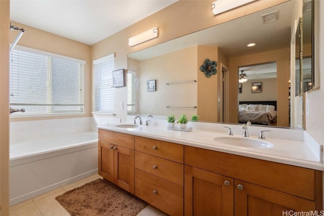 ensuite bathroom with a sink, tile patterned flooring, ensuite bath, and a bath