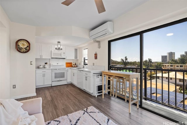 kitchen featuring sink, white appliances, dark hardwood / wood-style floors, white cabinets, and an AC wall unit