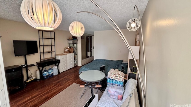 living room with a textured ceiling and wood finished floors