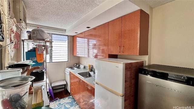 washroom with a textured ceiling, wood finished floors, and a sink