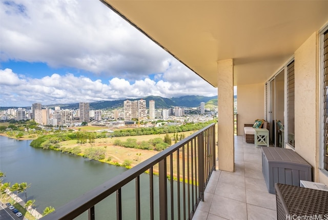 balcony with a water view and a city view