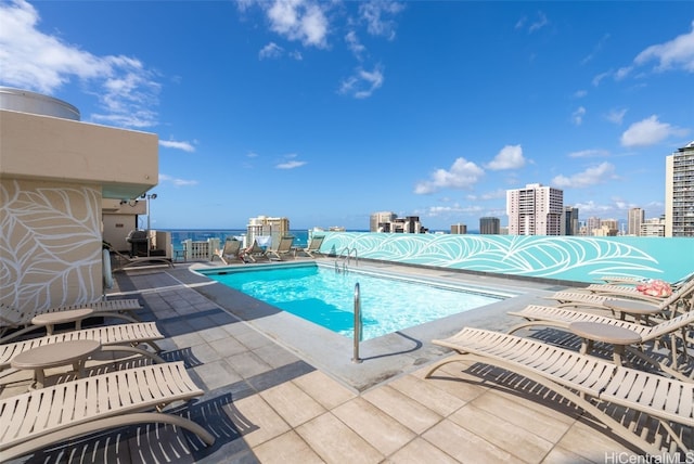 pool featuring a view of city and a patio area