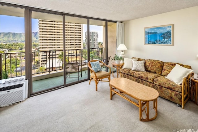 living room with expansive windows, a textured ceiling, and carpet flooring