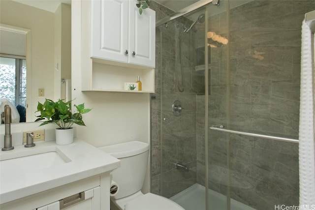 full bathroom with toilet, a shower stall, and vanity