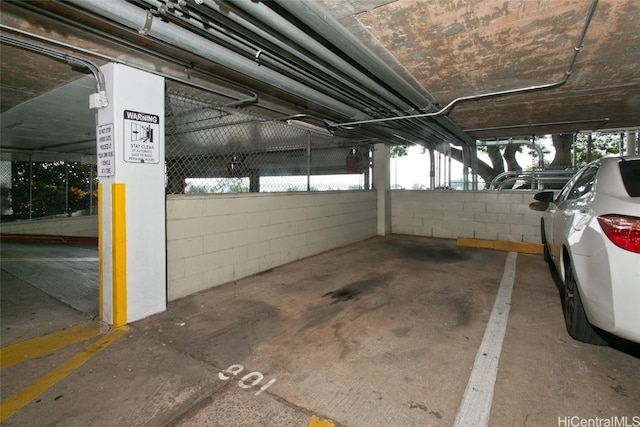 parking garage featuring concrete block wall