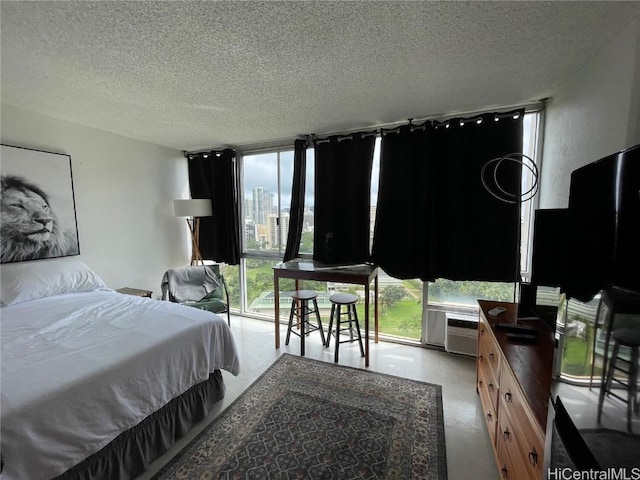 bedroom with floor to ceiling windows and a textured ceiling