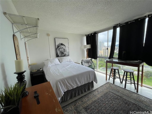 bedroom with expansive windows and a textured ceiling