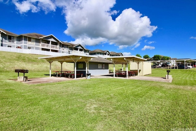 back of house with a gazebo and a yard