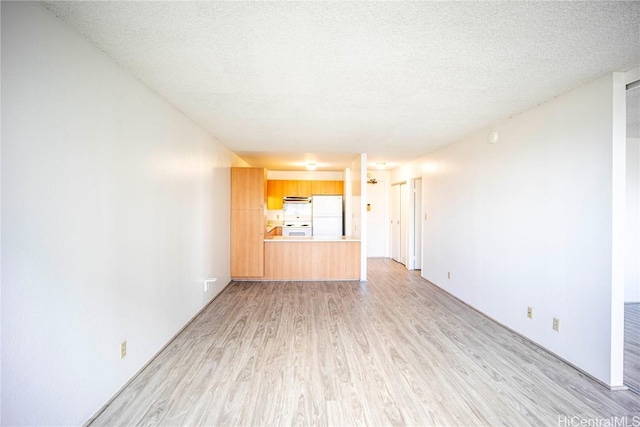 unfurnished living room featuring a textured ceiling and light hardwood / wood-style floors