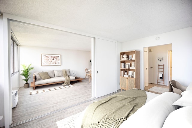 living room featuring a textured ceiling and light wood-type flooring