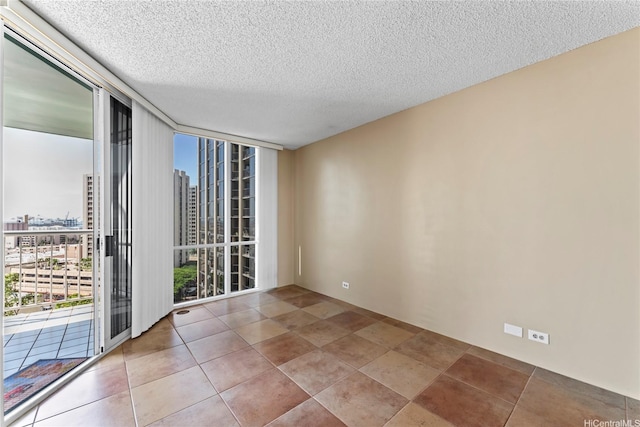 1212 Nuuanu Ave Unit 1412, Honolulu, HI 96817 - spare room featuring a view of city, a textured ceiling, and expansive windows