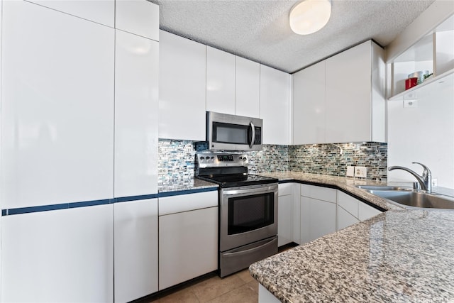 1212 Nuuanu Ave Unit 1412, Honolulu, HI 96817 - kitchen featuring a sink, white cabinets, stainless steel appliances, and tasteful backsplash