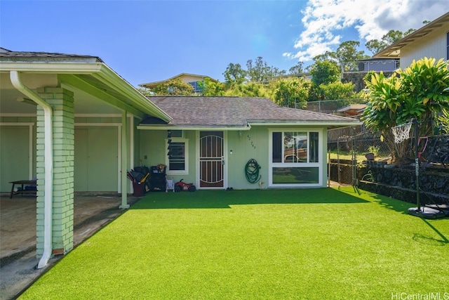 rear view of house featuring a lawn