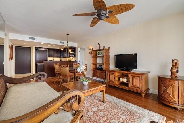 living room with dark hardwood / wood-style floors and ceiling fan