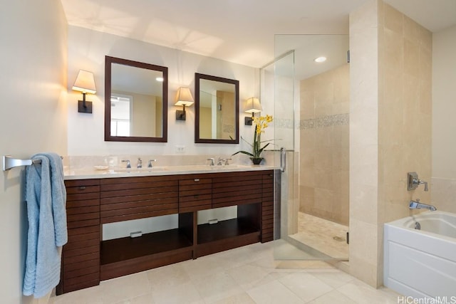 bathroom featuring vanity and independent shower and bath