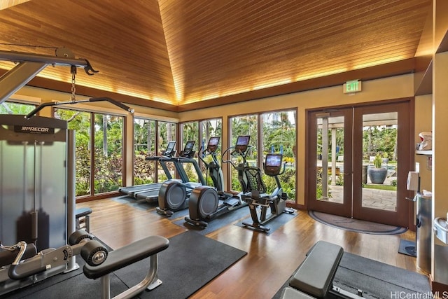 exercise room with wood-type flooring, lofted ceiling, wooden ceiling, and french doors