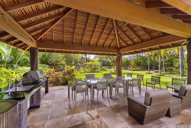 view of patio with a gazebo, area for grilling, and sink