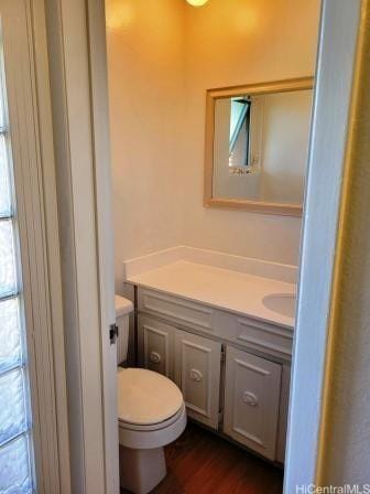 bathroom featuring hardwood / wood-style flooring, vanity, and toilet