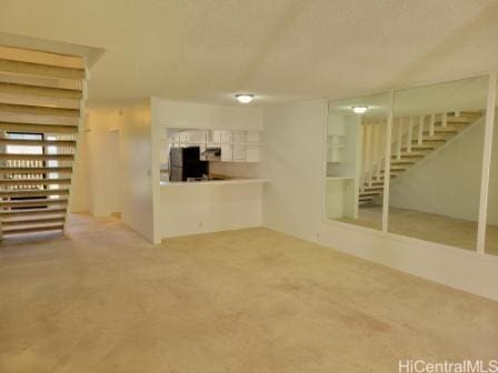 unfurnished living room with carpet floors