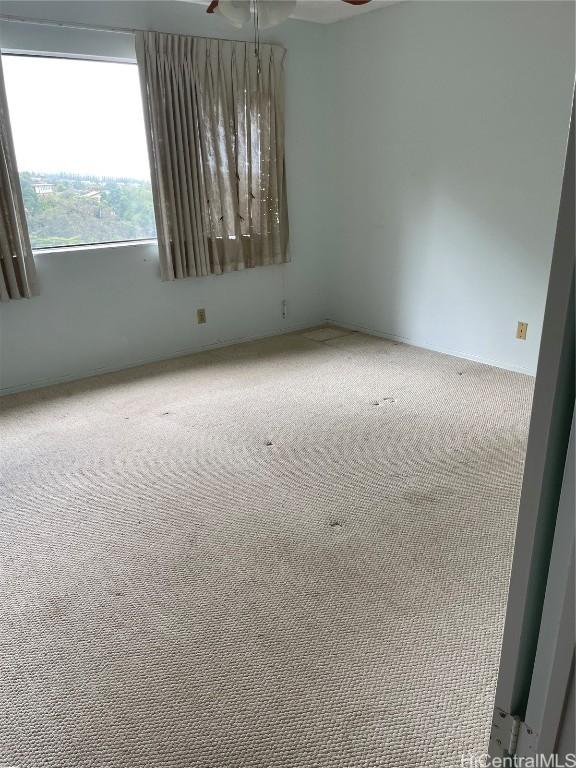 carpeted empty room featuring ceiling fan