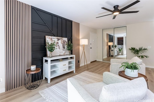 living room featuring ceiling fan and light hardwood / wood-style flooring