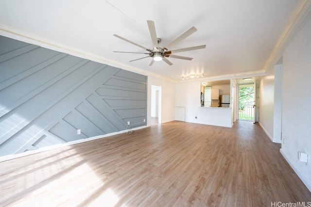 unfurnished living room with wood-type flooring and ceiling fan