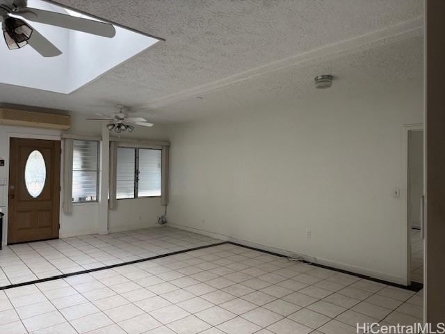 entrance foyer featuring a ceiling fan, light tile patterned flooring, and plenty of natural light