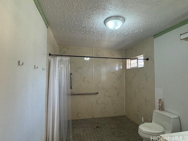 bathroom featuring a textured ceiling, a stall shower, and toilet