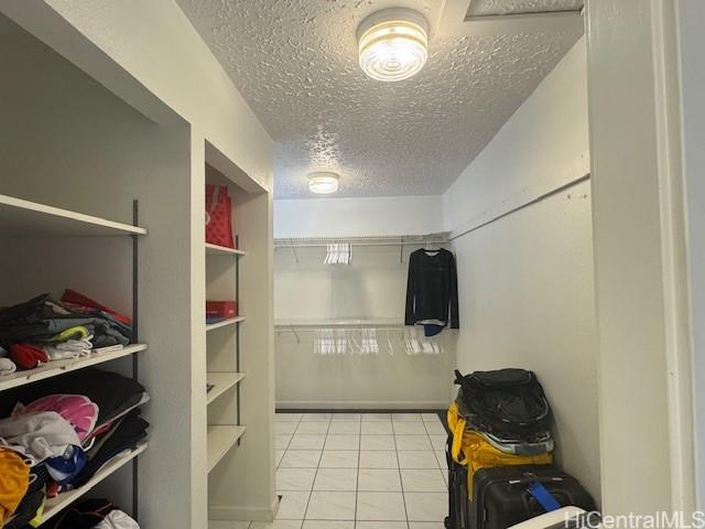 spacious closet with light tile patterned floors