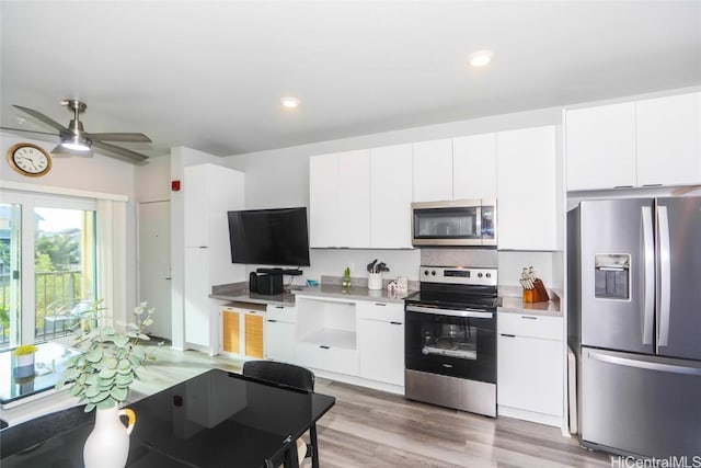 kitchen with white cabinetry, light wood-type flooring, ceiling fan, and appliances with stainless steel finishes