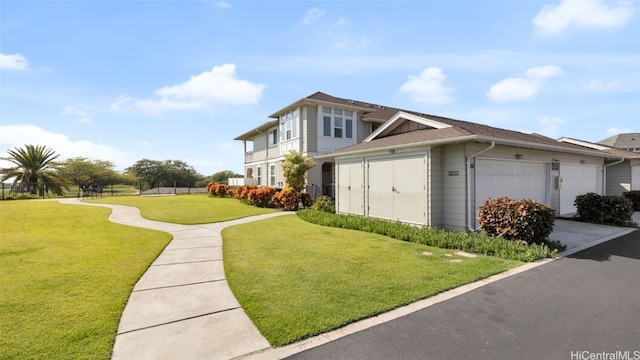 view of side of home featuring a garage and a yard