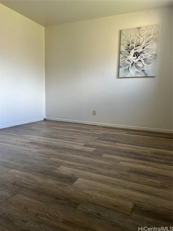 spare room with dark wood-type flooring