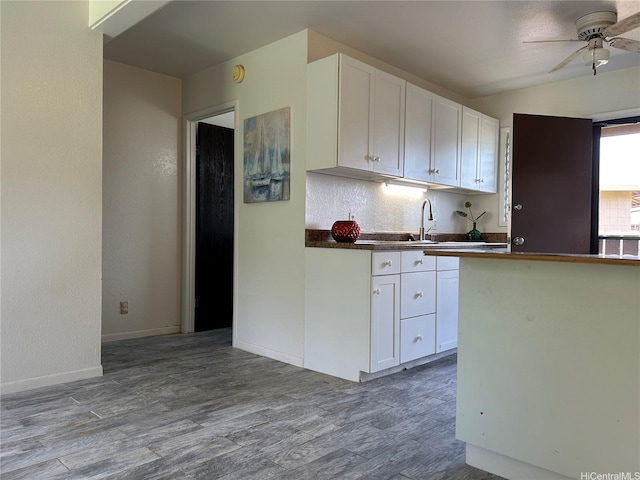98-1385 Hinu Pl Unit 77, Pearl City, HI 96782 - kitchen featuring ceiling fan, white cabinetry, wood finished floors, dark countertops, and lofted ceiling