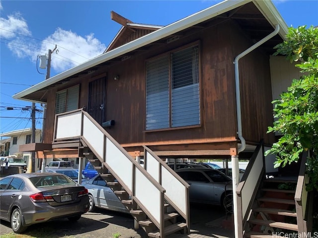 doorway to property featuring a carport