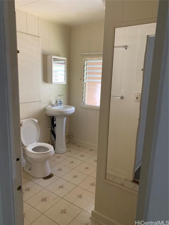 bathroom featuring tile patterned floors, toilet, and sink